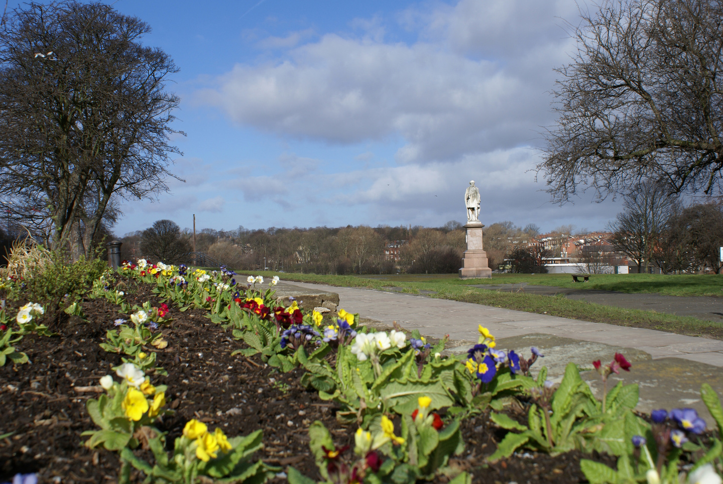 Student Accommodation in Hyde Park, Leeds - Flowers and statue of HR Marsden in Hyde Park, Leeds